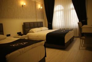 a hotel room with two beds and a window at Vista Kayseri Hotel in Kayseri