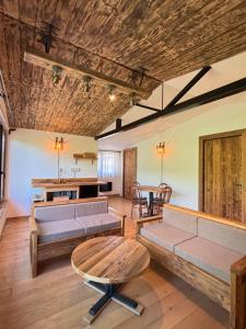a living room with couches and a table at Stone Village Transfagarasan in Oeștii Ungureni