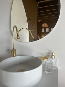 a bathroom with a white sink and a mirror at Escapade in Saint-Jouin-Bruneval +4 photos
