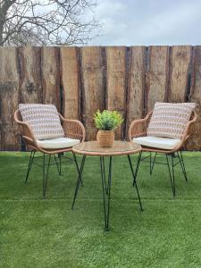 two chairs and a table with a potted plant on it at Escapade in Saint-Jouin-Bruneval