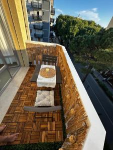 a balcony with a bench and a table on a balcony at Bibione Beach Home in Bibione