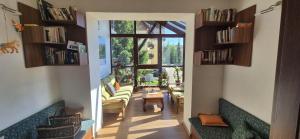 a room with a hallway with couches and a window at Penzión Sibír Bed & Breakfast in Starý Smokovec