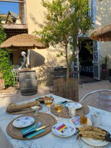 a table with plates of food and drinks on it at Le Grand Bain in Marciac
