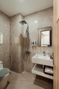 a bathroom with a sink and a shower at The Serenity Hanoi in Hanoi +45 photos