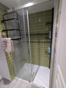 a shower with a glass door in a bathroom at La Cachette Floracoise in Florac +6 photos