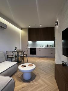 a living room with a couch and a table at Kresowy View Apartment in Biłgoraj