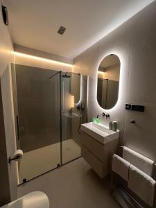 a bathroom with a shower and a sink and a mirror at Kresowy View Apartment in Biłgoraj +16 photos