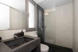 a bathroom with a sink and a toilet and a mirror at St Aims by Bluesites in Porto Heli +39 photos