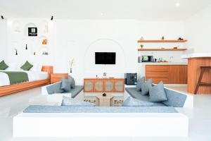 a living room with a bed and a couch at Dita Villa Uluwatu in Bingin Beach