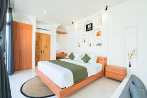 a bedroom with a bed and a couch at Dita Villa Uluwatu in Bingin Beach +13 photos