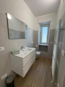 a white bathroom with a sink and a toilet at LA CASETTA - Clusone in Clusone