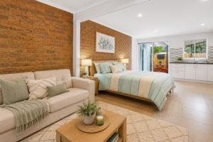 a living room with a bed and a couch at Golfside Getaway 2 by Ready Set Stay in Rosebud