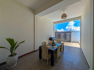 a dining room with a table and chairs and a large window at Villa Goli 3BR Private Pool Villa, Paje in Zanzibar City