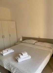 a bedroom with a bed with towels on it at RESIDENCE Erminia in Novara