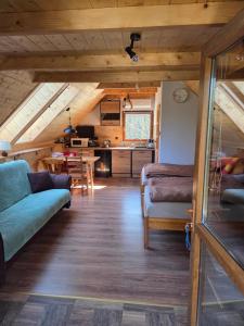 a living room with a couch and a table at Dolina Izerów in Sucha
