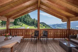 a large screened in porch with a table and chairs at Moarlhof - Farm Nature Resort in Castelrotto