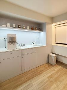 a kitchen with white cabinets and a window at Monomer Hostel Bangkok in Bangkok +93 photos