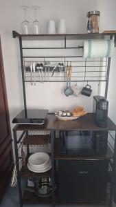 a table with a laptop on a shelf with utensils at Hellas Makari B&B in Macari +71 photos