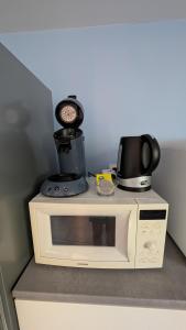 a microwave with a coffee pot on top of it at HOME HOSE in Monistrol-sur-Loire