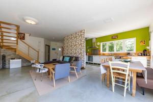 a living room and kitchen with a table and chairs at Maison Au Petit Bonheur in Argenton-sur-Creuse