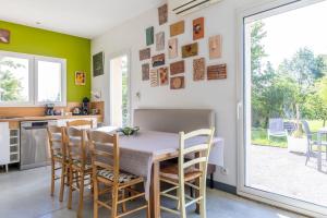a kitchen and dining room with a table and chairs at Maison Au Petit Bonheur in Argenton-sur-Creuse