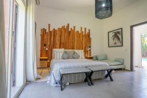 a bedroom with a bed and a couch in it at Villa Cactus in Ben Larbi +38 photos
