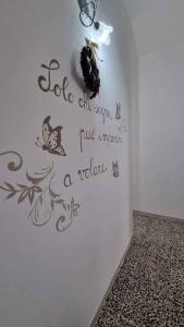 a wall with a sign on a wall with butterflies at L'appartamento di Tricase in Tricase