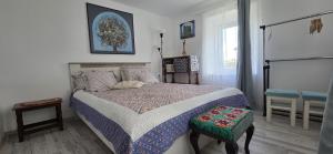 a bedroom with a bed and a window at Iancina House & Art Gallery in Salcioara