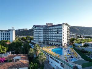 a hotel with a swimming pool in a city at Arora Hotel in Kuşadası