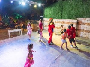 a group of children dancing on a stage with a clown at Arora Hotel in Kuşadası +122 photos