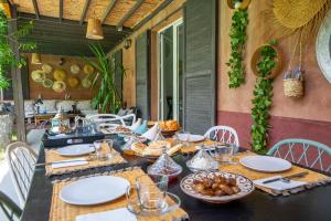 a table with plates of food on a patio at Villa Cactus in Ben Larbi