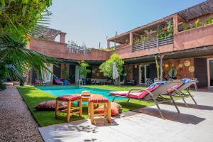 a patio with a table and chairs next to a pool at Villa Cactus in Ben Larbi