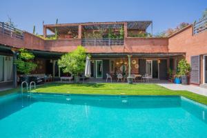 a house with a swimming pool in the yard at Villa Cactus in Ben Larbi