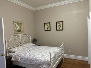 a bedroom with a white bed and three pictures on the wall at Private unit in richmond hill in Richmond Hill