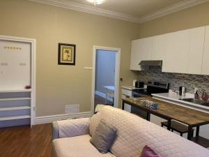 a living room with a couch and a kitchen at Private unit in richmond hill in Richmond Hill