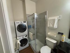 a bathroom with a washing machine and a washer at Private unit in richmond hill in Richmond Hill