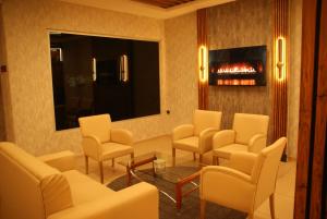 a waiting room with chairs and a fire place at Vista Kayseri Hotel in Kayseri