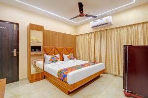 a bedroom with a bed and a flat screen tv at FabHotel Royal Atlantis Studio Apartments in Chennai