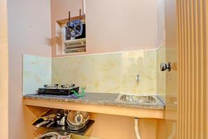 a kitchen with a sink and a counter top at FabHotel Royal Atlantis Studio Apartments in Chennai +20 photos