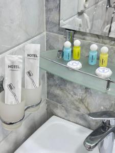 a bathroom with a sink and a shelf with towels at A-Hotel Ex Magistral in Solnechnyy +31 photos