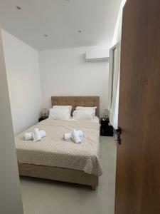 a bedroom with two beds with towels on them at Makridakis apartments in Rethymno