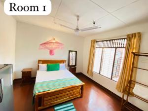 a bedroom with a bed and a chandelier at Oracle Residence in Anuradhapura