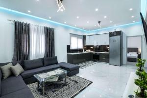 a living room with a couch and a kitchen at Aurelio Luxury Apartments in Paloúkia