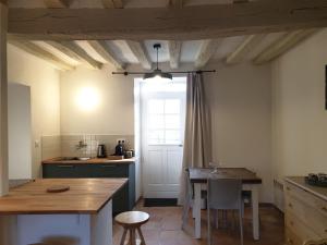 a kitchen with a table and a window in it at Studio de Bresteau in Beillé +4 photos