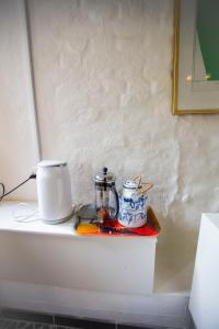 a counter top with a coffee pot and cups on it at Private 2 prs basement I spacious & central CPH in Copenhagen