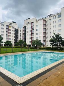 an empty swimming pool in front of apartment buildings at Luxe Haven in Nairobi +5 photos