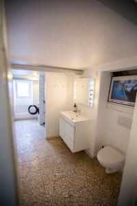 a bathroom with a white sink and a toilet at Private 2 prs basement I spacious & central CPH in Copenhagen +18 photos