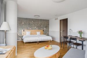 a hotel room with a bed and a table with fruit on it at 2Home Hotel Apartments in Solna +50 photos