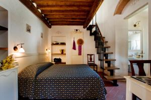a bedroom with a bed and a staircase at Hotel Corallo in Pomonte