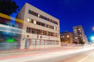 a building on the side of a street at night at Tatamka Hostel in Warsaw